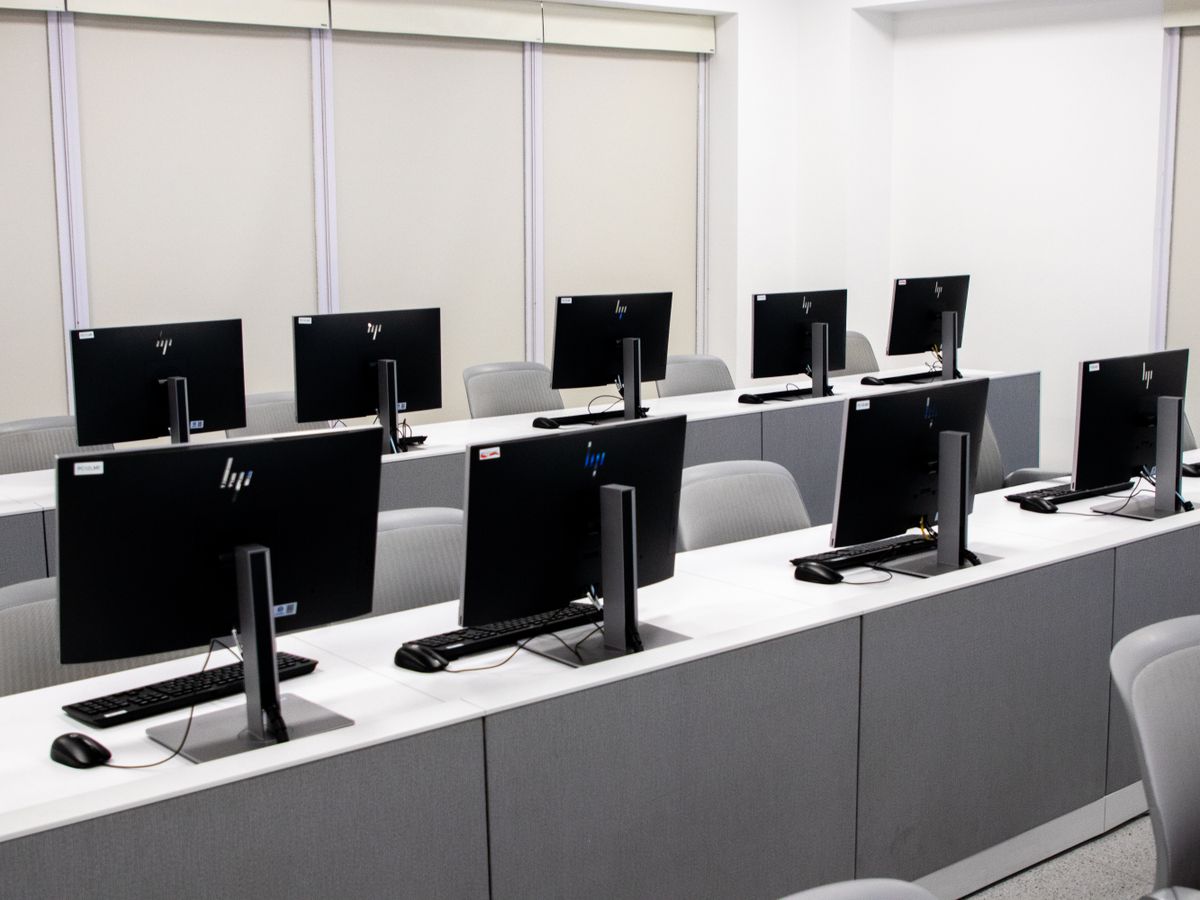 Rows of identical school computers in a computer lab